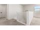 Upstairs landing featuring neutral carpet, white railings and a view of the staircase at 9837 E Satellite Dr, Mesa, AZ 85212