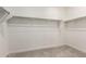 Walk-in closet with carpeted flooring and metal hanging racks for clothing storage at 9837 E Satellite Dr, Mesa, AZ 85212