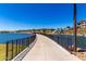 Picturesque view of the walking path, waterfront, and nearby homes, creating a serene and appealing neighborhood scene at 9837 E Satellite Dr, Mesa, AZ 85212