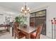 Dining room with a wooden table, leather chairs, modern chandelier, and sliding glass doors at 10626 N 8Th St, Phoenix, AZ 85020