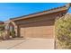 Two-car garage on tan home with beautiful desert landscaping, a red tile roof and clear blue sky at 10626 N 8Th St, Phoenix, AZ 85020