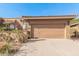 Tan home exterior with a red tile roof, complemented by desert landscaping and a spacious two-car garage at 10626 N 8Th St, Phoenix, AZ 85020