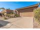 Spacious tan home with two-car garage, mature landscaping, and a red tile roof under a clear blue sky at 10626 N 8Th St, Phoenix, AZ 85020