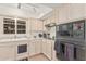 Well lit kitchen with white cabinets, neutral countertops, and modern appliances at 10626 N 8Th St, Phoenix, AZ 85020