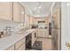Galley style kitchen with white cabinets, stainless steel appliances, and tiled floors at 10626 N 8Th St, Phoenix, AZ 85020