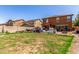 View of the backyard showing the houses next door with a block wall and grass at 12128 W Range Mule Dr, Peoria, AZ 85383