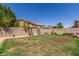 Large backyard with grass, block fencing, wooden swing and mature trees at 12128 W Range Mule Dr, Peoria, AZ 85383