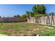 Large grassy backyard with brick wall and swing set at 12128 W Range Mule Dr, Peoria, AZ 85383