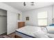 Bedroom with closet and dresser, featuring wood-look floors, a ceiling fan, and a window with natural light at 12128 W Range Mule Dr, Peoria, AZ 85383