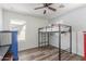Bright bedroom featuring a loft bed, ceiling fan, and wood-look flooring at 12128 W Range Mule Dr, Peoria, AZ 85383