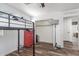 Bedroom featuring a loft bed, closet, hardwood floors, and natural light at 12128 W Range Mule Dr, Peoria, AZ 85383