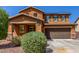 Attractive two-story home with a well-manicured front yard and a convenient two-car garage at 12128 W Range Mule Dr, Peoria, AZ 85383