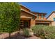 Well-maintained home showcasing a welcoming front entrance and landscaped front yard at 12128 W Range Mule Dr, Peoria, AZ 85383