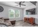 Living room with ceiling fan, large windows, entertainment console and comfortable sectional sofa at 12128 W Range Mule Dr, Peoria, AZ 85383