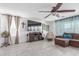 Relaxing living room with tile floors, large TV, and comfortable seating at 12128 W Range Mule Dr, Peoria, AZ 85383