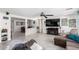 Open-concept living room with a spacious layout, tile floors and a clear view of the dining area at 12128 W Range Mule Dr, Peoria, AZ 85383