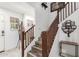 Bright foyer featuring a wooden staircase and neutral decor at 12128 W Range Mule Dr, Peoria, AZ 85383