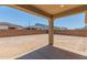 Expansive backyard under a covered patio, with a block fence at 12389 W Marguerite Ave, Avondale, AZ 85323