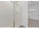 Clean bathroom with a glass-enclosed shower and a doorway leading to a walk-in closet at 12389 W Marguerite Ave, Avondale, AZ 85323