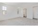 Bright bedroom with neutral carpet, large windows, and an ensuite bathroom view at 12389 W Marguerite Ave, Avondale, AZ 85323