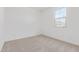 Bright, carpeted bedroom with neutral walls and a window providing ample light at 12389 W Marguerite Ave, Avondale, AZ 85323
