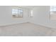 Bright bedroom with plush carpet and multiple windows for ample natural light at 12389 W Marguerite Ave, Avondale, AZ 85323