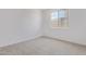 Bright bedroom with neutral carpet, a large window, and simple electrical outlets at 12389 W Marguerite Ave, Avondale, AZ 85323