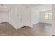Inviting entryway with a white door and neutral-toned wood-look tile flooring, leading to a bright living space at 12389 W Marguerite Ave, Avondale, AZ 85323