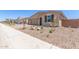 Single-story residence with a three-car garage and stone-accented landscaping for a stylish, low-maintenance appeal at 12389 W Marguerite Ave, Avondale, AZ 85323