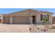 Attractive single-story home with a three-car garage, complemented by tidy landscaping and a quaint arched entryway at 12389 W Marguerite Ave, Avondale, AZ 85323