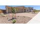 Well-manicured front yard with a three-car garage and a charming single-story facade at 12389 W Marguerite Ave, Avondale, AZ 85323