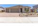 Charming single-story home featuring a three-car garage and a well-maintained, xeriscaped front yard at 12389 W Marguerite Ave, Avondale, AZ 85323