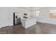 Modern kitchen with white cabinets, stainless steel appliances, and center island at 12389 W Marguerite Ave, Avondale, AZ 85323