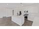 Modern kitchen featuring white cabinetry, stainless steel appliances, and a spacious center island at 12389 W Marguerite Ave, Avondale, AZ 85323