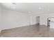Spacious and bright living room featuring wood-look tile flooring and ample natural light at 12389 W Marguerite Ave, Avondale, AZ 85323