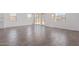 Expansive living area with wood-look tile, bathed in natural light from the sliding glass doors and surrounding windows at 12389 W Marguerite Ave, Avondale, AZ 85323