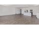 Open-concept living area with modern kitchen view and wood-look tile throughout at 12389 W Marguerite Ave, Avondale, AZ 85323