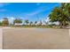 Outdoor basketball court featuring well-maintained surfaces and mature trees, perfect for recreational games at 1245 W Lobo Ave, Mesa, AZ 85202