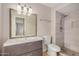 Stylish bathroom featuring a modern vanity, a toilet, and a tiled walk-in shower at 1245 W Lobo Ave, Mesa, AZ 85202