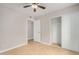 Neutral bedroom with ceiling fan, tile floors, closet and doorway at 1245 W Lobo Ave, Mesa, AZ 85202