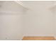 A walk-in closet with a clean, minimalist design and tile flooring at 1245 W Lobo Ave, Mesa, AZ 85202