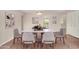 Elegant dining room showcasing a marble-topped table with seating for six and stylish decor at 1245 W Lobo Ave, Mesa, AZ 85202