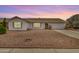 Charming single-story home boasting a low-maintenance landscape and a welcoming facade during dusk at 1245 W Lobo Ave, Mesa, AZ 85202