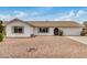 Single-story home with a well-maintained exterior, low-maintenance rock landscaping, and a spacious driveway at 1245 W Lobo Ave, Mesa, AZ 85202