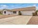 Single-Gathering home featuring a spacious driveway and a low-maintenance xeriscaped front yard, perfect for easy upkeep at 1245 W Lobo Ave, Mesa, AZ 85202