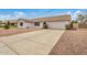 Charming single-story home with a two car garage and well maintained front yard at 1245 W Lobo Ave, Mesa, AZ 85202