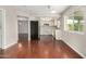 A cozy kitchen featuring appliances, white cabinets, and wood flooring at 1245 W Lobo Ave, Mesa, AZ 85202
