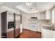 Bright kitchen with white cabinetry, modern appliances, and hardwood flooring at 1245 W Lobo Ave, Mesa, AZ 85202