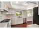 This kitchen boasts hardwood floors, white cabinets, stainless steel appliances, and ample counter space at 1245 W Lobo Ave, Mesa, AZ 85202