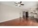 The living room boasts a ceiling fan, wood floors, and an open layout connecting to the kitchen at 1245 W Lobo Ave, Mesa, AZ 85202